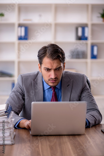 Young male employee working in the office