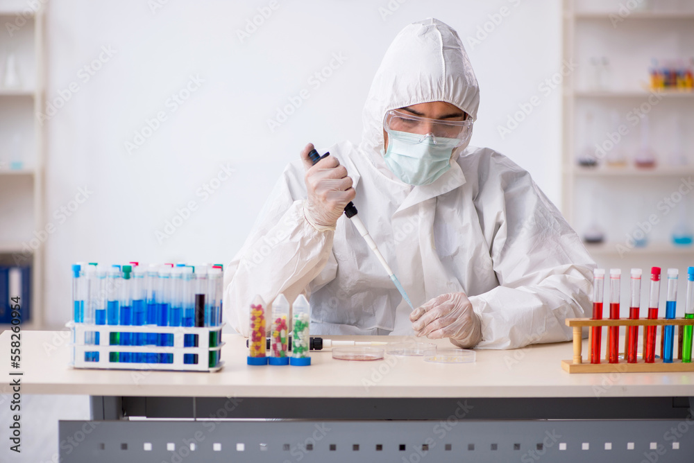 Young male chemist in drugs synthesis concept Young male chemist in drugs synthesis concept