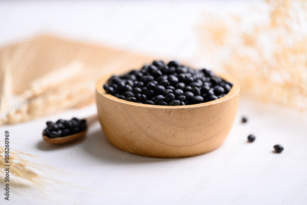 Black soybean seeds in bowl with spoon, food ingredients high protein good for vegetarian and vegan Black soybean seeds in bowl with spoon, food ingredients high protein good for vegetarian and vegan