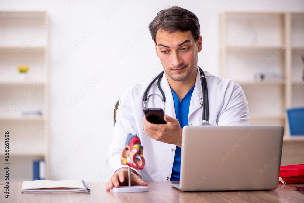 Young male doctor cardiologist working in the clinic Young male doctor cardiologist working in the clinic