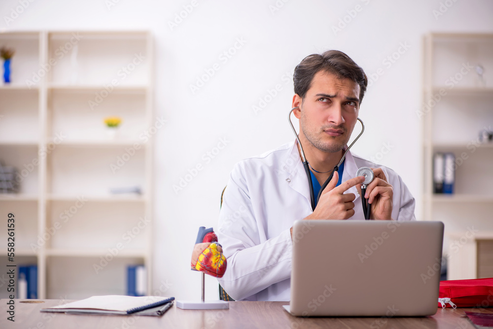 Young male doctor cardiologist working in the clinic Young male doctor cardiologist working in the clinic