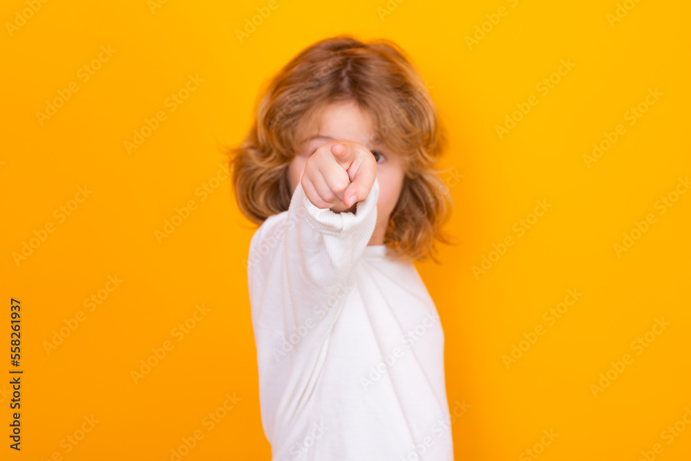 Surprised child pointing at you on yellow isolated studio background. Shocked kid pointing to copyspace, showing promo offers, points away. Surprised child pointing at you on yellow isolated studio background. Shocked kid pointing to copyspace, showing promo offers, points away.