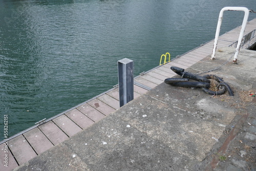 Shipping pier by ocean with mooring hooks and attachments