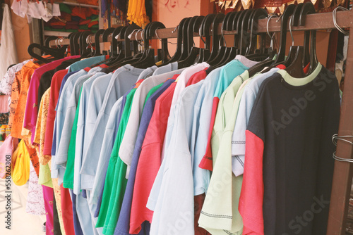 Clothing store. Summer clothes - T-shirts, T-shirts, long sleeves hang on hangers. © d_odin