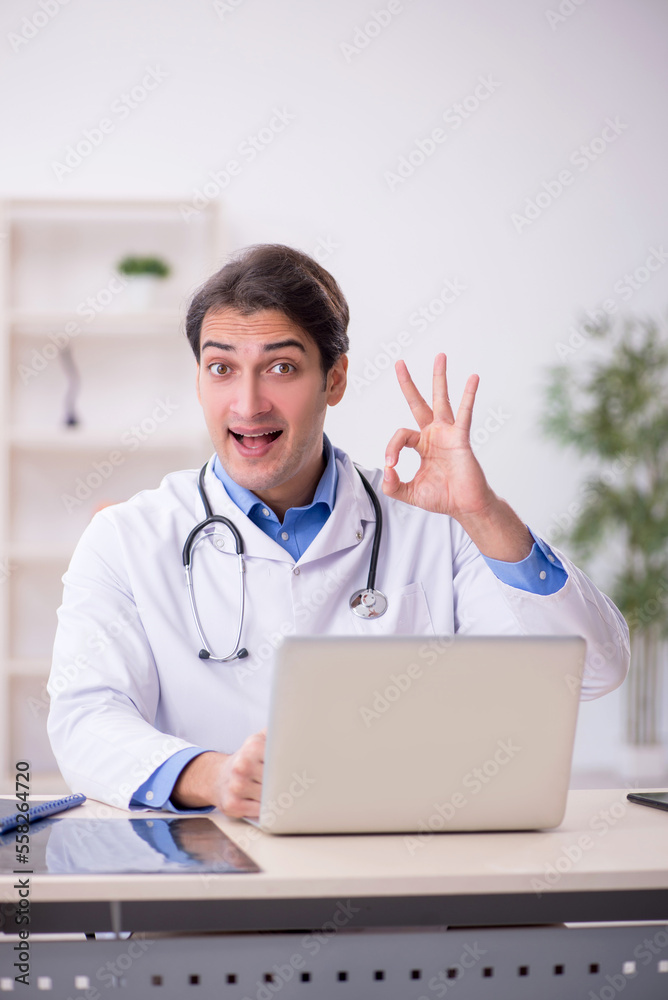 Young male doctor in telemedicine concept Young male doctor in telemedicine concept