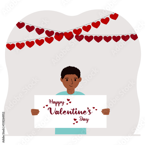 Happy little boy holding a poster with text Happy Valentine's Day and red hearts. Love concept. Happy Valentine's Day wallpaper, poster, postcard or congratulation.
