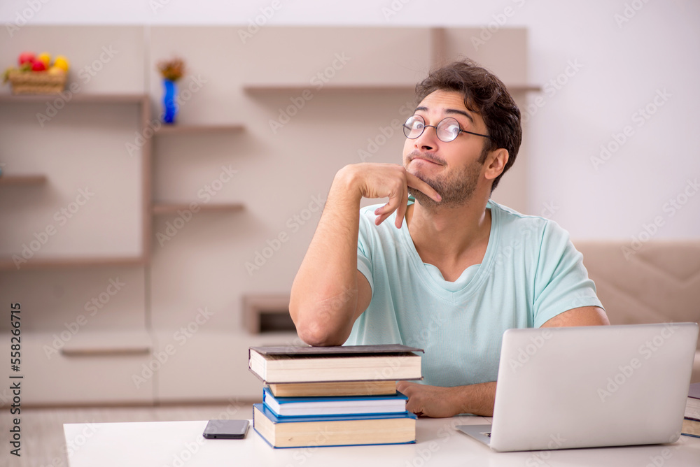 Young male student preparing for exams at home Young male student preparing for exams at home