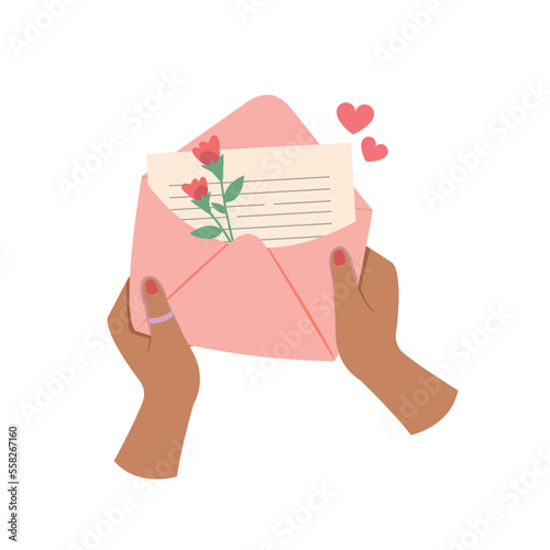 Hands holding envelope with heart and flowers, Sending written letter concept.