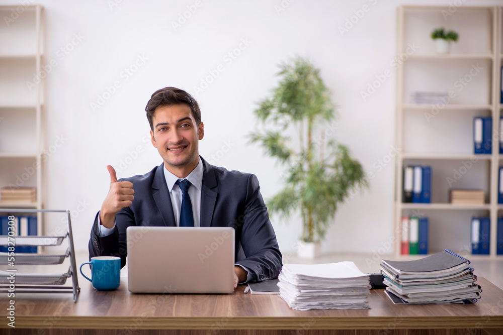 Young male employee working in the office Young male employee working in the office