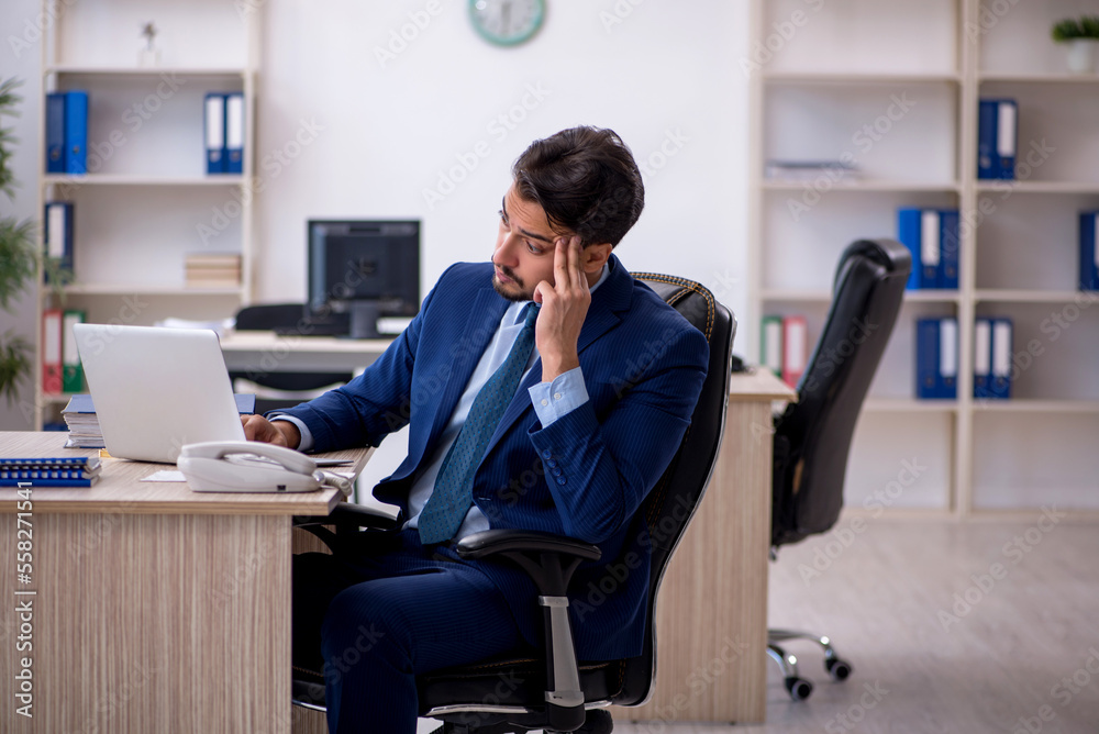 Young male employee working in the office
