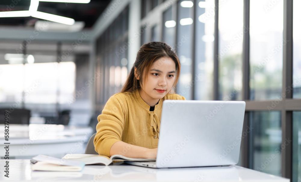 portrait of Asian female student studying at university library portrait of Asian female student studying at university library