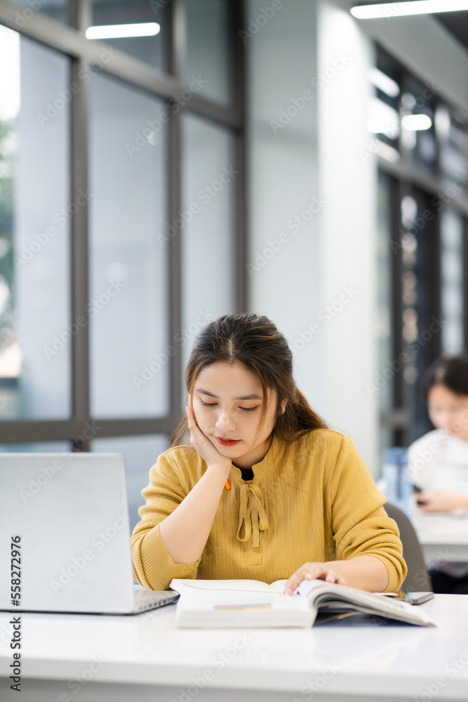 portrait of Asian female student studying at university library portrait of Asian female student studying at university library