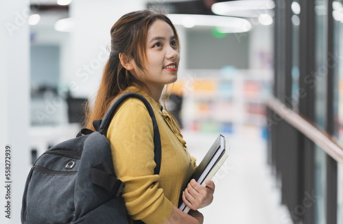 portrait of Asian female student studying at university library