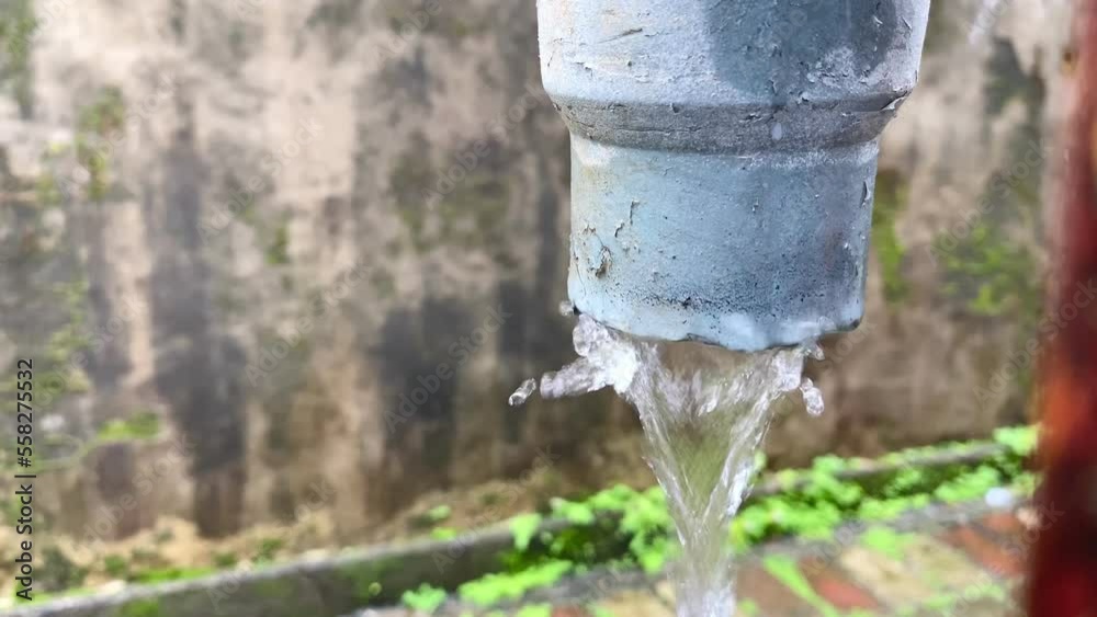 Close Up water flows out through the pipe. flows of water pours out of the drain pipe. Rainwater flows from the roof through the drain pipe Close Up water flows out through the pipe. flows of water pours out of the drain pipe. Rainwater flows from the roof through the drain pipe