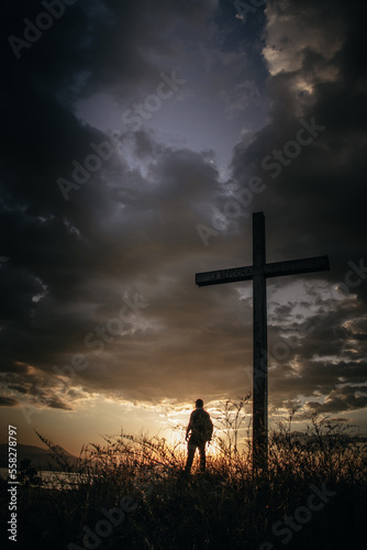 silhouette of a person with cross