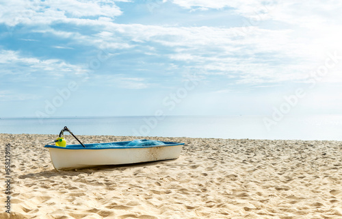 Fishing boat on tropical sandy beach, summer outdoor day light