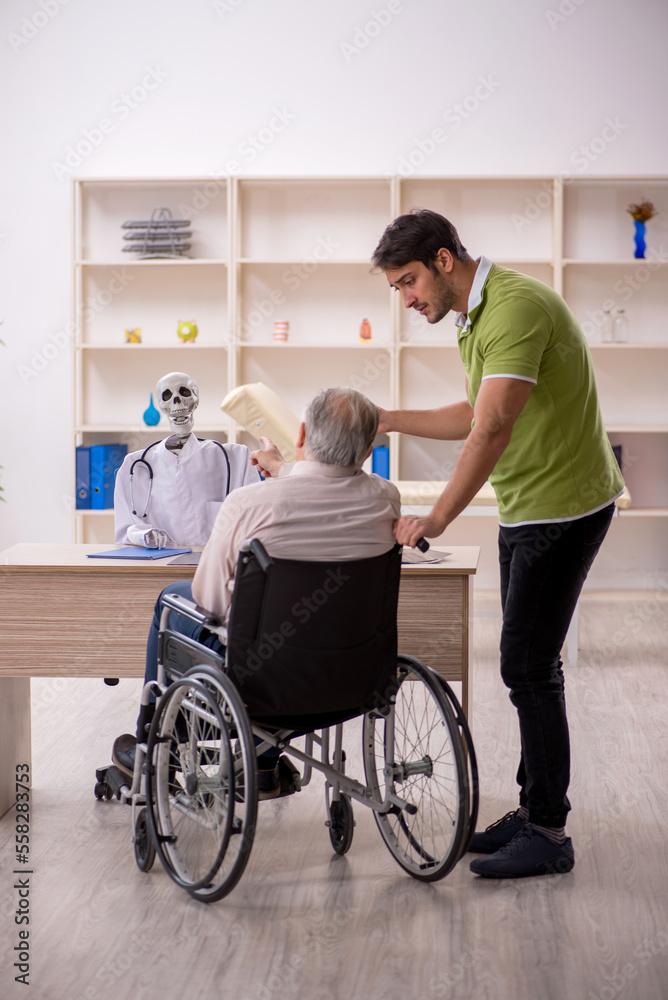 Old patient in wheel-chair visiting skeleton doctor Old patient in wheel-chair visiting skeleton doctor
