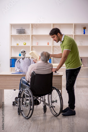 Old patient in wheel-chair visiting skeleton doctor © Elnur