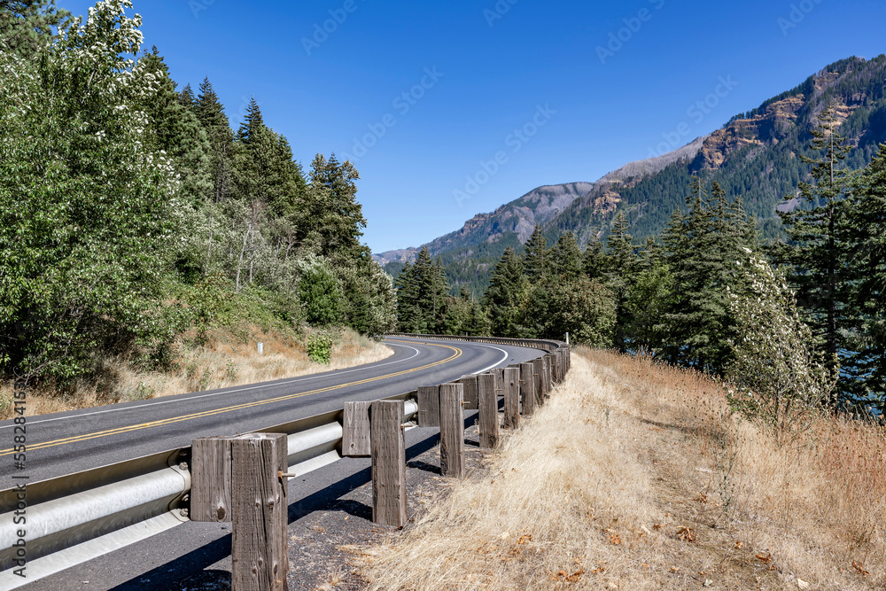 Security fence of a winding highway road in the scenic Columbia Gorge National Reserve area