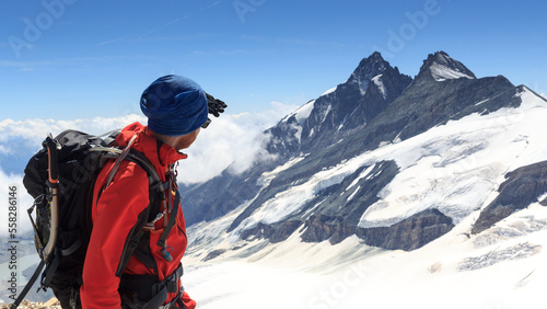 Mountaineer looking towards mountain Grossglockner and glacier Pasterze panorama in Glockner Group, Austria