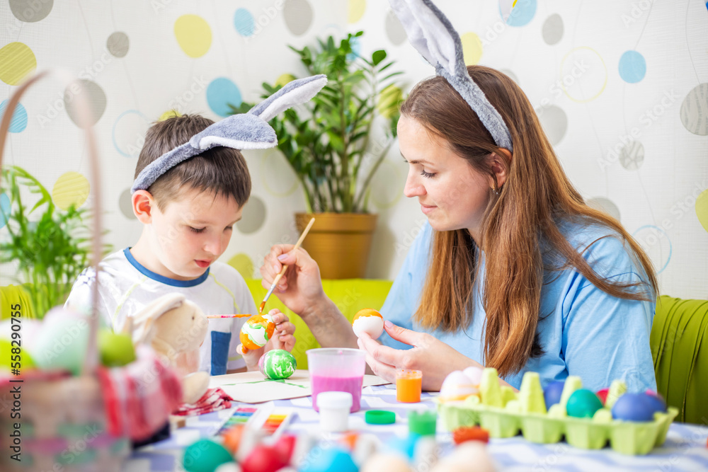Happy Easter. A mother and her son painting Easter eggs Happy Easter. A mother and her son painting Easter eggs