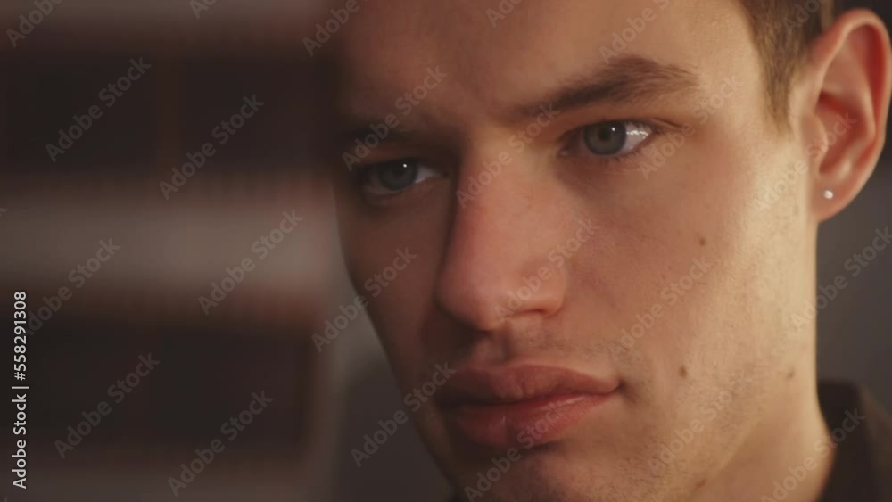 Face Of A Man Looking At Film Negatives In Blurred Foreground. closeup Face Of A Man Looking At Film Negatives In Blurred Foreground. closeup