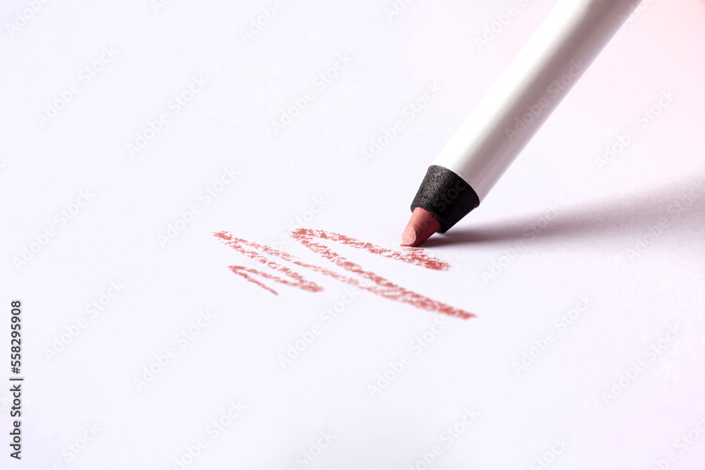 Cosmetic pencil and stroke isolated on white. Make-up pencil red strokes on white paper. Macro photo Cosmetic pencil and stroke isolated on white. Make-up pencil red strokes on white paper. Macro photo