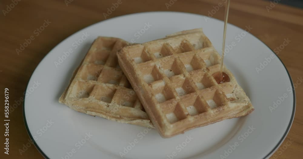 Close Up Slow Motion of Syrup Being Poured onto Waffles