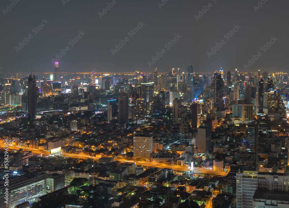 Fototapeta premium Aerial view of Bangkok Downtown Skyline, Thailand. Financial district and business centers in smart urban city in Asia. Skyscraper and high-rise buildings at night.