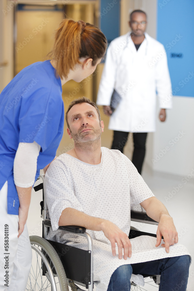 Obraz premium female nurse talking to disabled patient in hospital