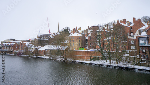 View of Durham city buildings near Framwellgate Bridge over the River Wear during winter snow morning in Durham , United Kingdom : 1 March 2018