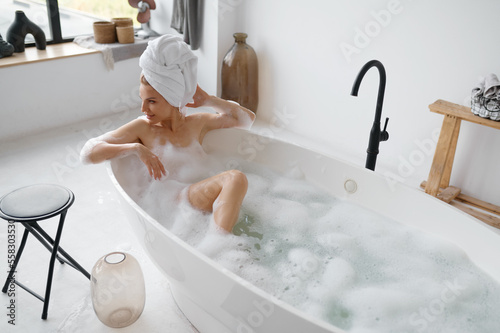 Fotografering Portrait of gorgeous woman in towel on head taking bath