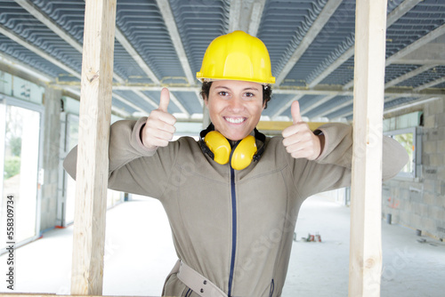woman builder shows thumb up