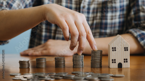 businessman holding coins putting in glass with using calculator to calculate concept saving money for finance accounting, Business, finance, investment, Financial planning.