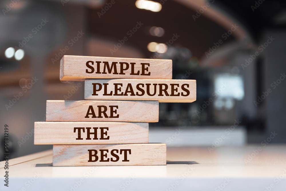 Wooden blocks with words 'Simple pleasures are the best'.