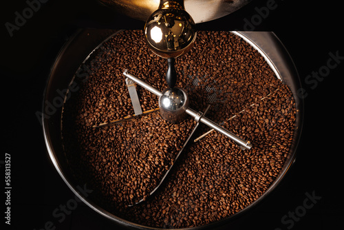 Roasting process coffee beans on professional mixing roaster machines, top view