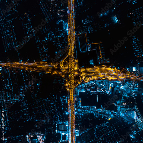 Photography Aerial top view of Modern Multilevel Motorway Junction with Toll Highway, Road traffic an important infrastructure, Expressway Road and Roundabout, Night scene, Transportation and travel concept