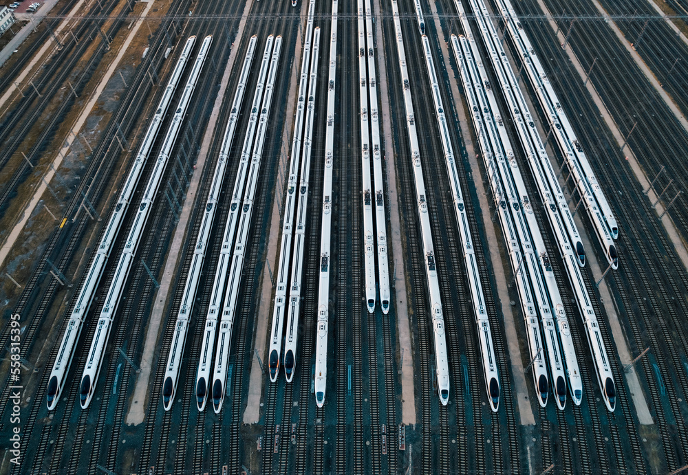 Aerial shots of multiple high-speed trains parked on railway tracks Aerial shots of multiple high-speed trains parked on railway tracks