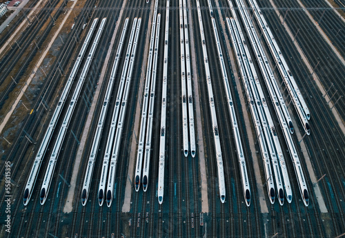 Aerial shots of multiple high-speed trains parked on railway tracks