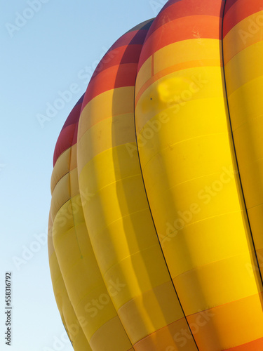 Hot air balloon inflated and against blue sky
