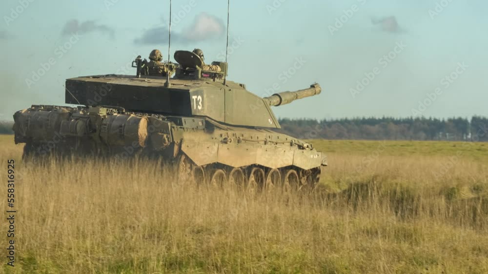 rear quarter profile of British army FV4034 Challenger 2 ii main battle tank in action on a military combat exercise, Wiltshire UK
