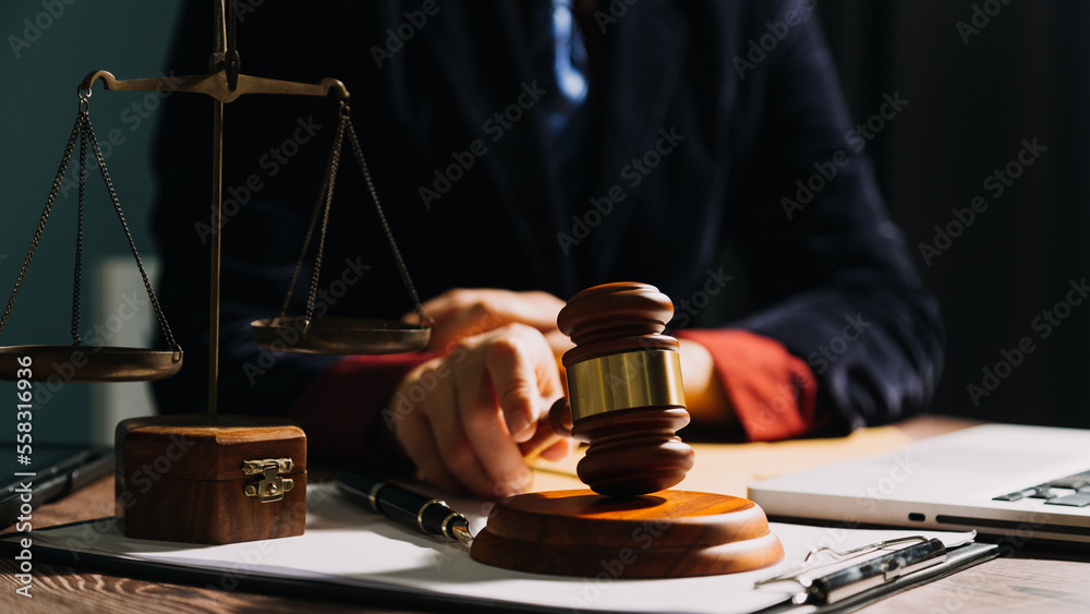 Business and lawyers discussing contract papers with brass scale on desk in office. Law, legal services, advice, justice and law concept picture with film grain effect