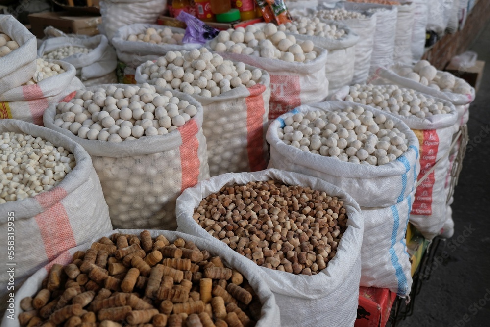 Big bags with kurut - dried cottage cheese in Osh Bazaar, central market in Bishkek, Kyrgyzstan.  