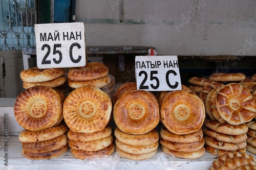 Stand of local bread in Osh Bazaar, central market in Bishkek, Kyrgyzstan. Traditional Kyrgyz bread named lipioshka, sold at a city bazaar.	
 photo