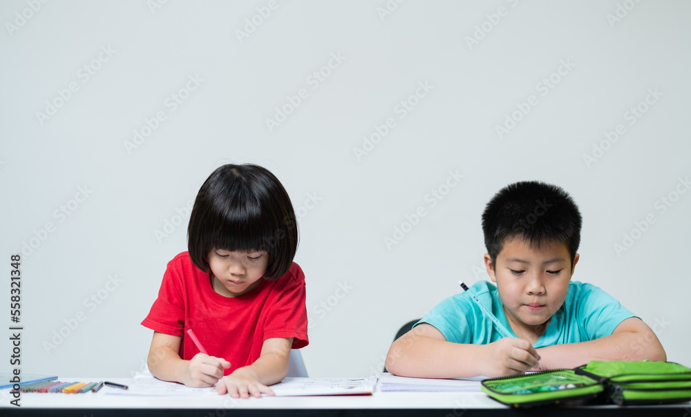 two children doing homework together, kid write paper, family concept, learning time, student reading book, back to school 
