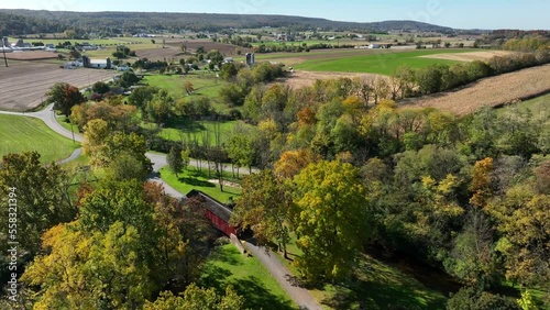 Rural Lancaster County Pennsylvania farmland and red covered bridge in autumn. Aerial view. photo