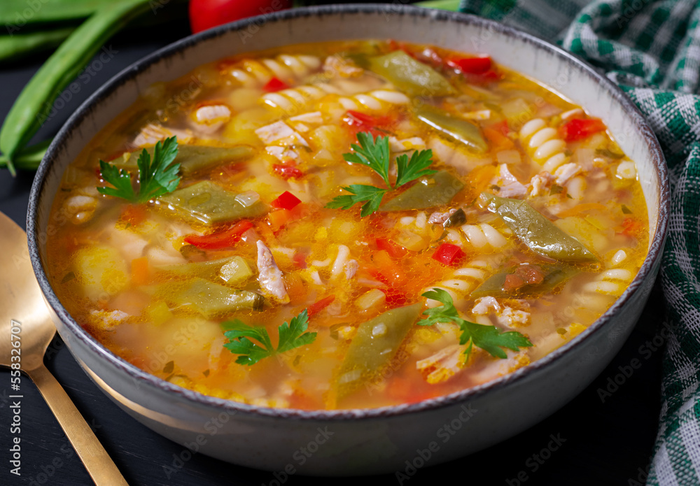 Minestrone, italian vegetable soup with pasta on black table. Minestrone, italian vegetable soup with pasta on black table.