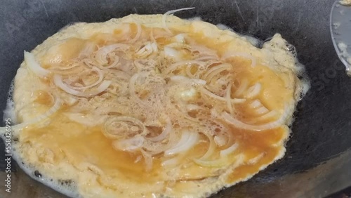 Omelets fried in hot coconut oil