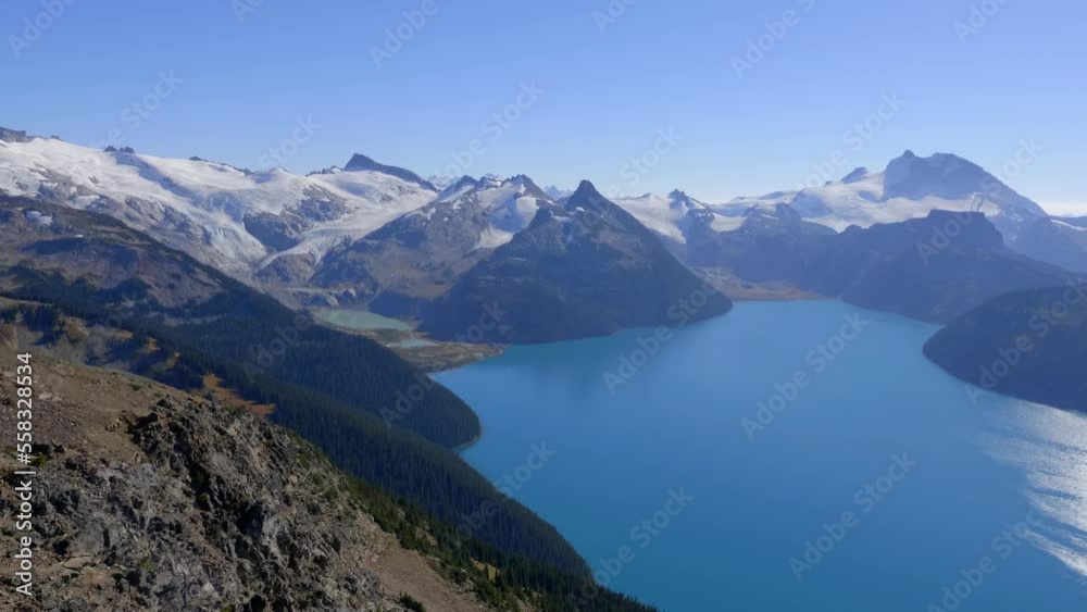 Idyllic Lake Surrounded By Snow Mountains With A Foggy Atmosphere. Aerial Wide Shot Idyllic Lake Surrounded By Snow Mountains With A Foggy Atmosphere. Aerial Wide Shot