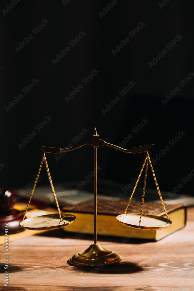 Business and lawyers discussing contract papers with brass scale on desk in office. Law, legal services, advice, justice and law concept picture with film grain effect